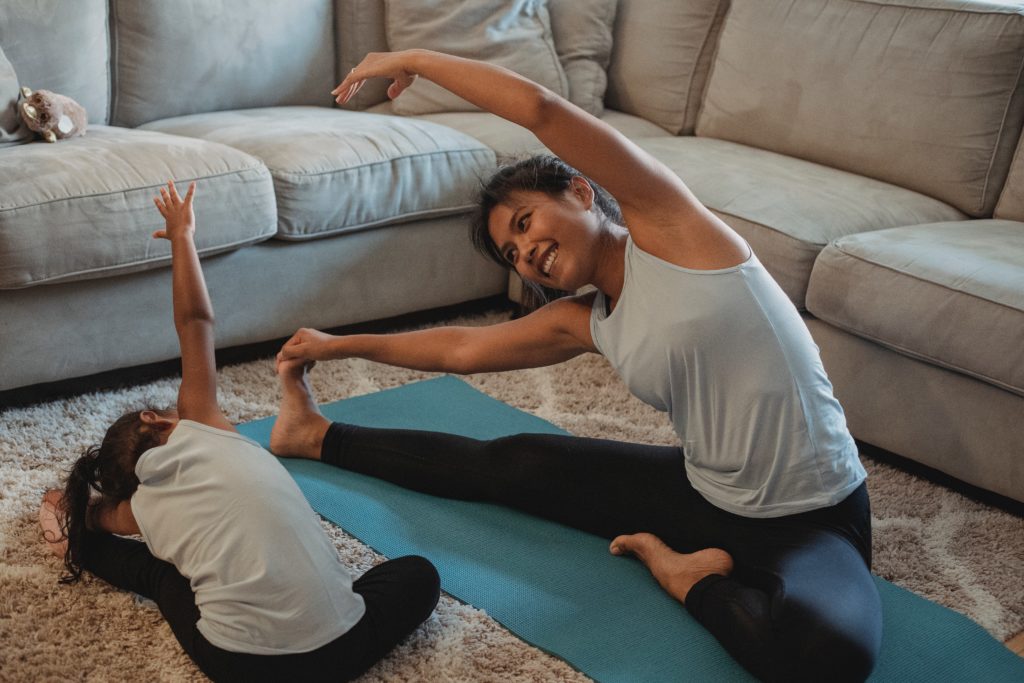 mother and child doing yoga together at home